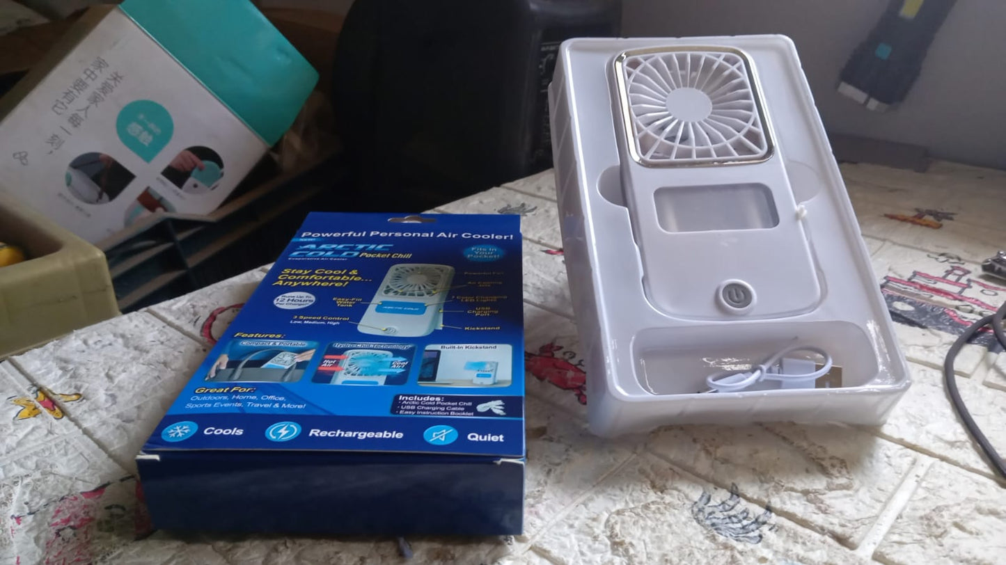 Lifestyle shot of the portable personal air cooler in use outdoors.