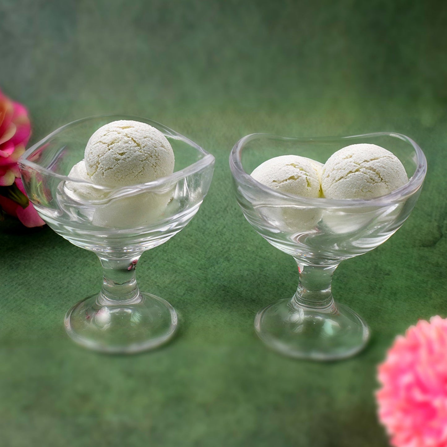 Two glass ice cream cups, showcasing their elegant footed design.