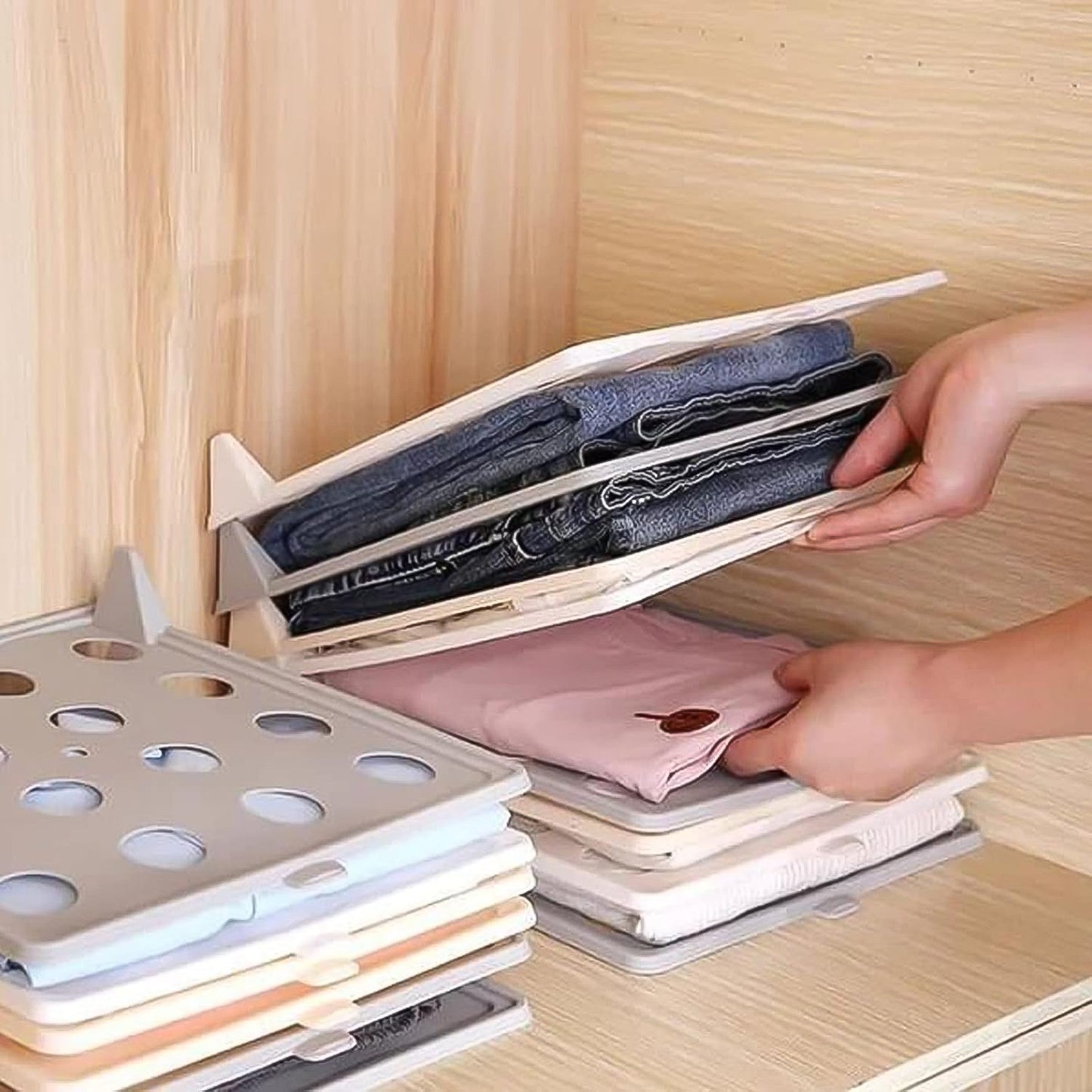 Wardrobe drawer with multiple Clothes Folding Boards neatly stacked, showcasing organized garments.