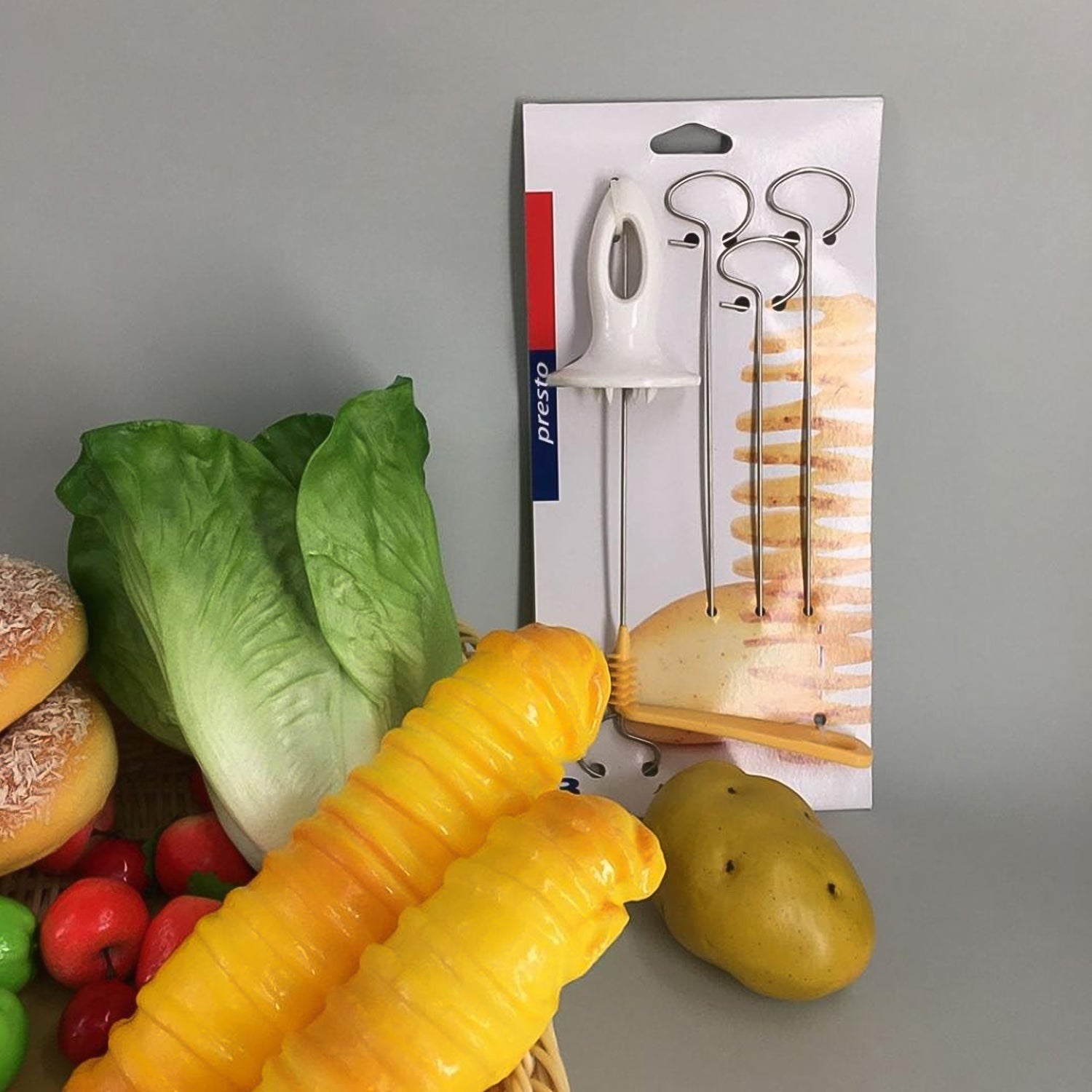 Side view of the manual potato spiral cutter on a white surface.