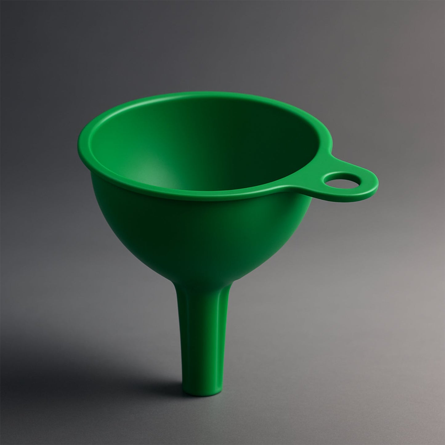 Bright red silicone funnel standing upright on a kitchen counter, ready for use.