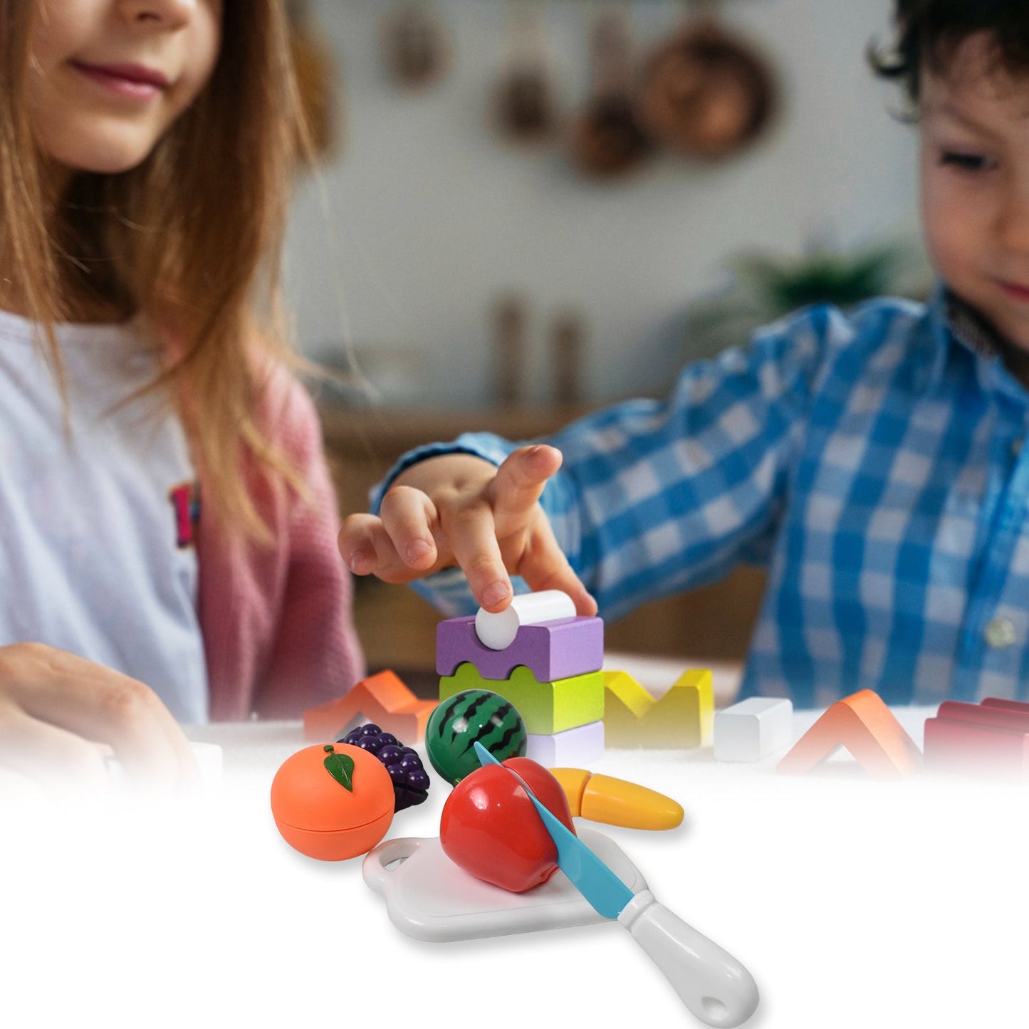 Child's hands demonstrating how to slice a toy watermelon on the included cutting board.