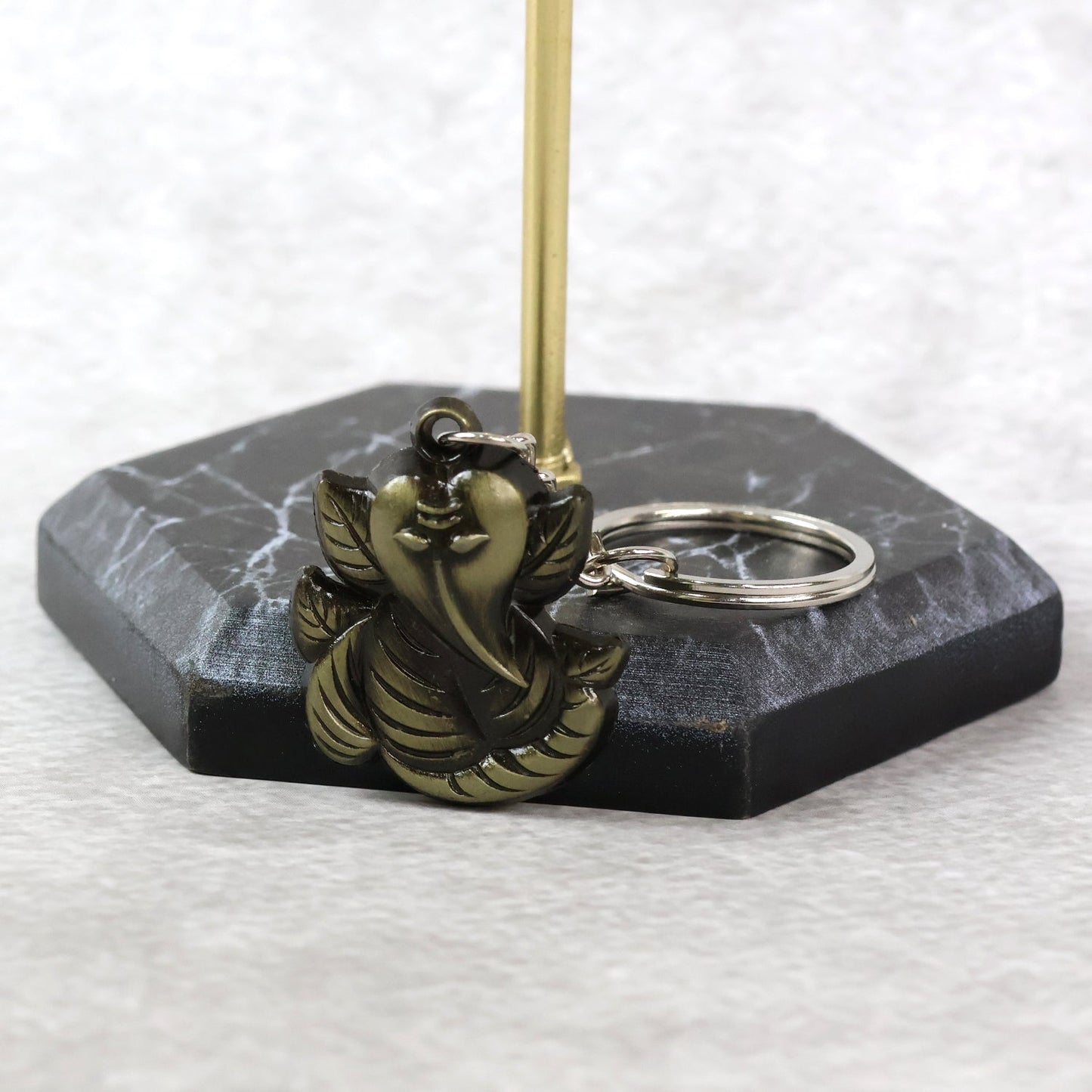 Side view of Ganesh Face Antique Black Metal Keychain displaying metal craftsmanship