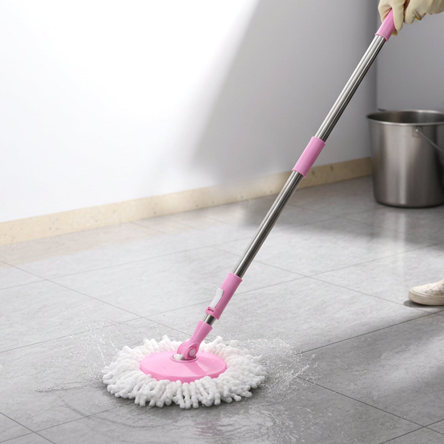User demonstrating the simple hands-free wringing action with the Quick Spin Mop.