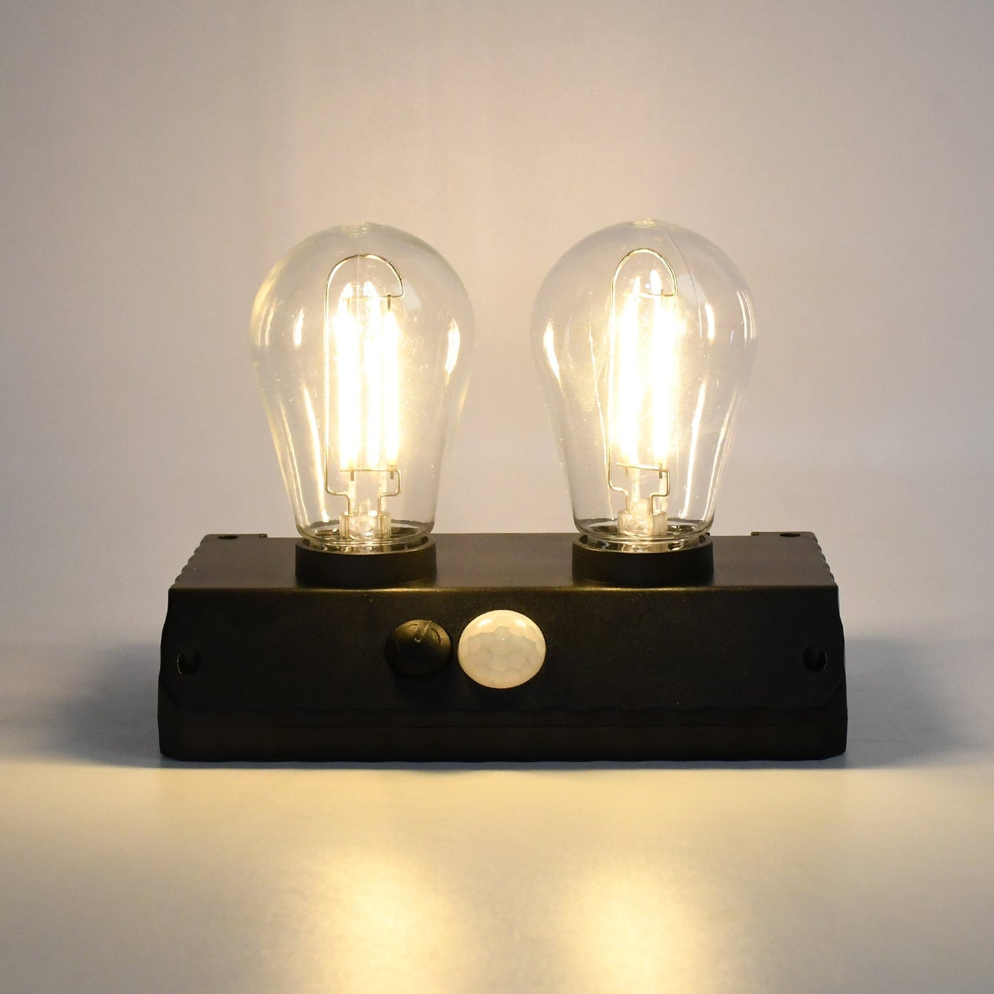 Indo Glow Solar Double LED Lamp providing ample light for an outdoor area.