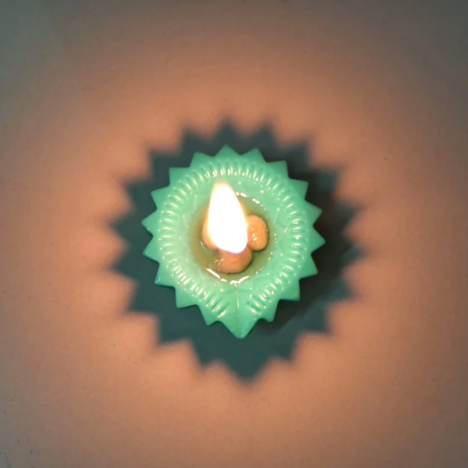 A stack of colourful silicone diyas, showcasing the attractive design and material.