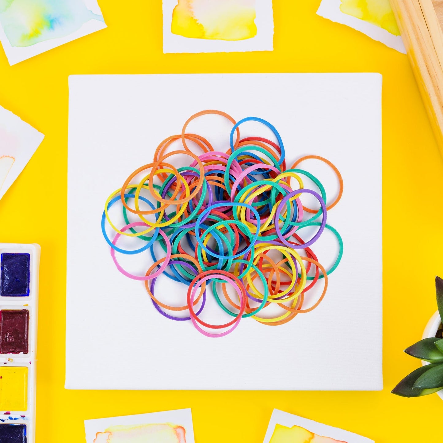 Vibrant multicolor rubber bands bundled together for office organization.