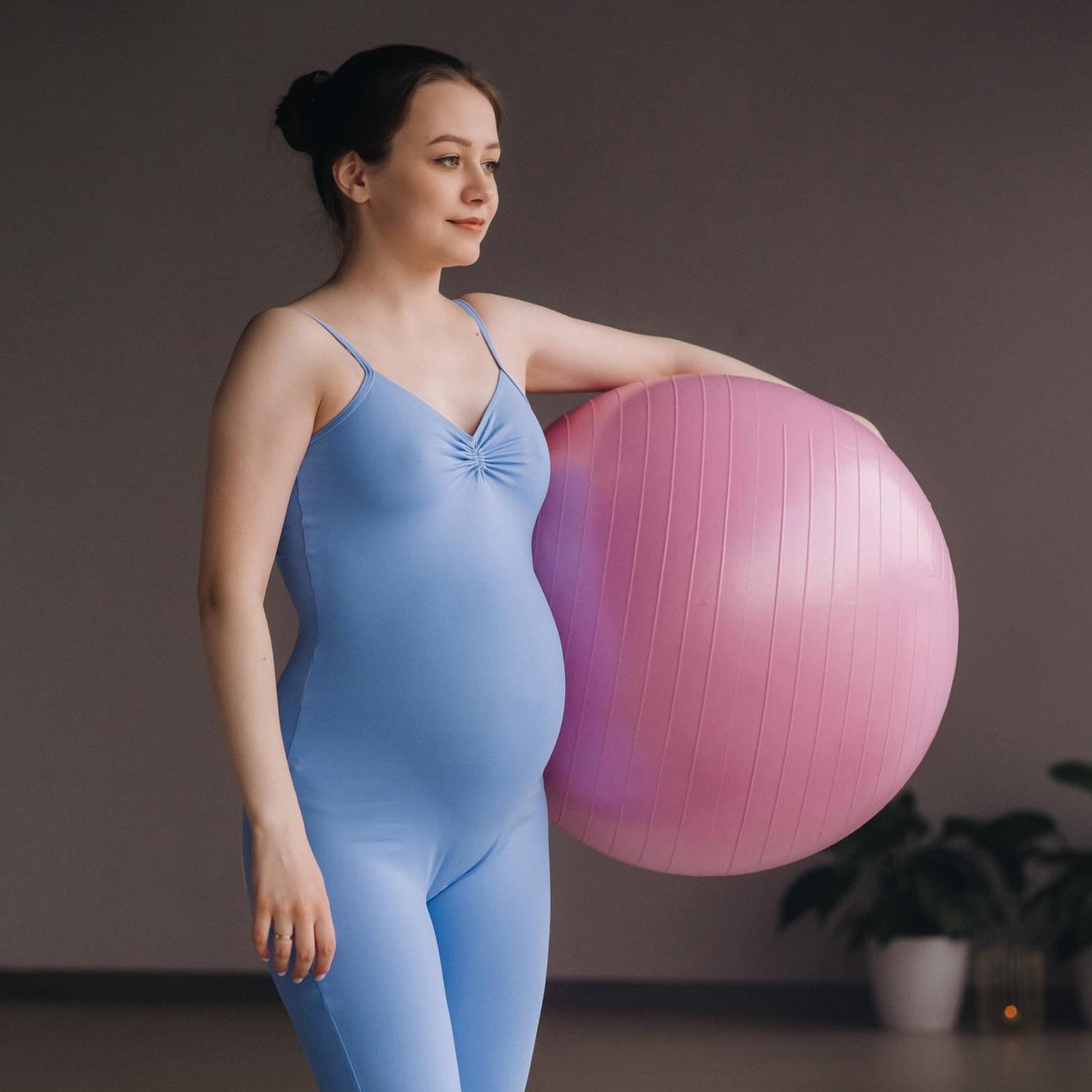 Person stretching their back on a blue 65 cm exercise ball, perfect for flexibility and yoga.