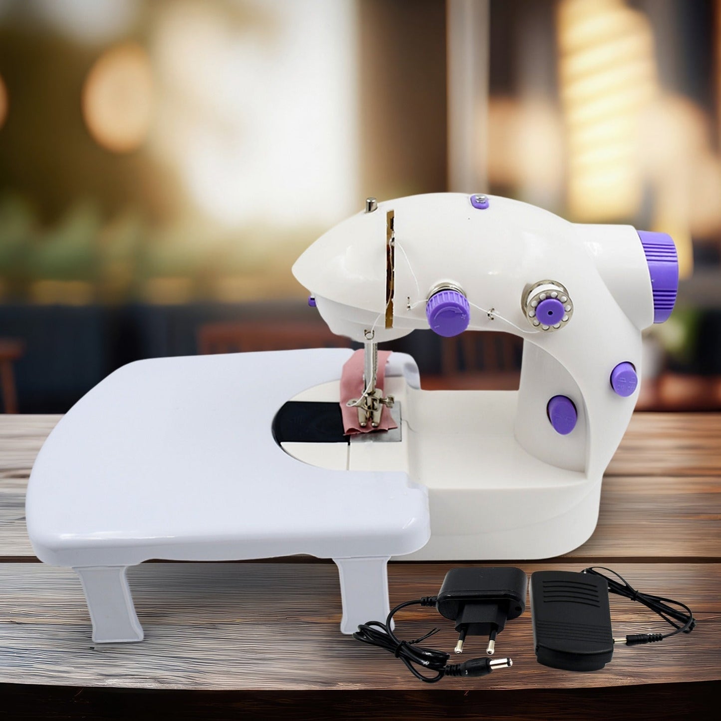 Mini Sewing Machine with extension table, foot pedal, and adapter on a clean surface.
