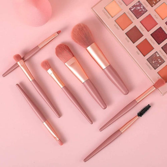 An 8-piece mini makeup brush set with a light pink handle and synthetic bristles, arranged neatly.