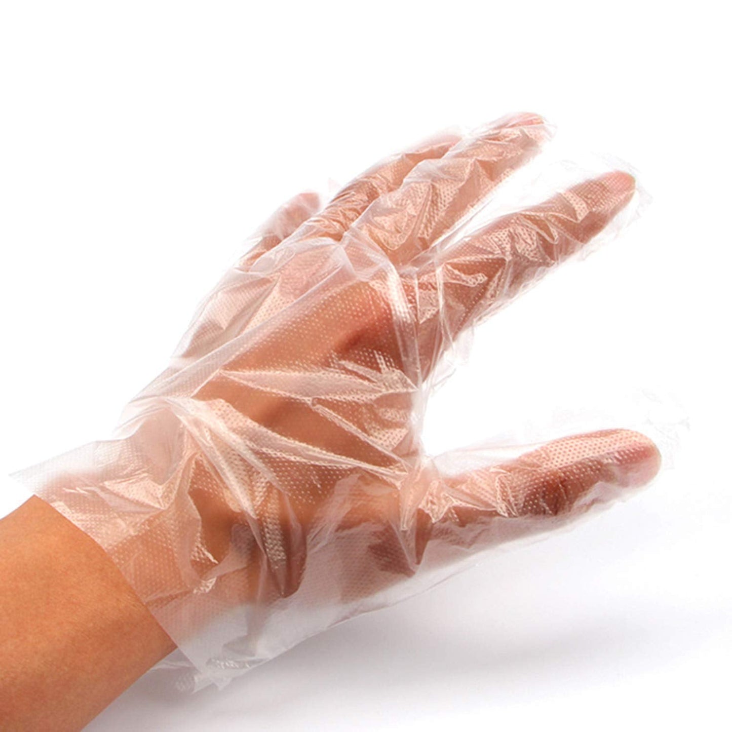 Person wearing disposable clear gloves while performing a task, ensuring hygiene.