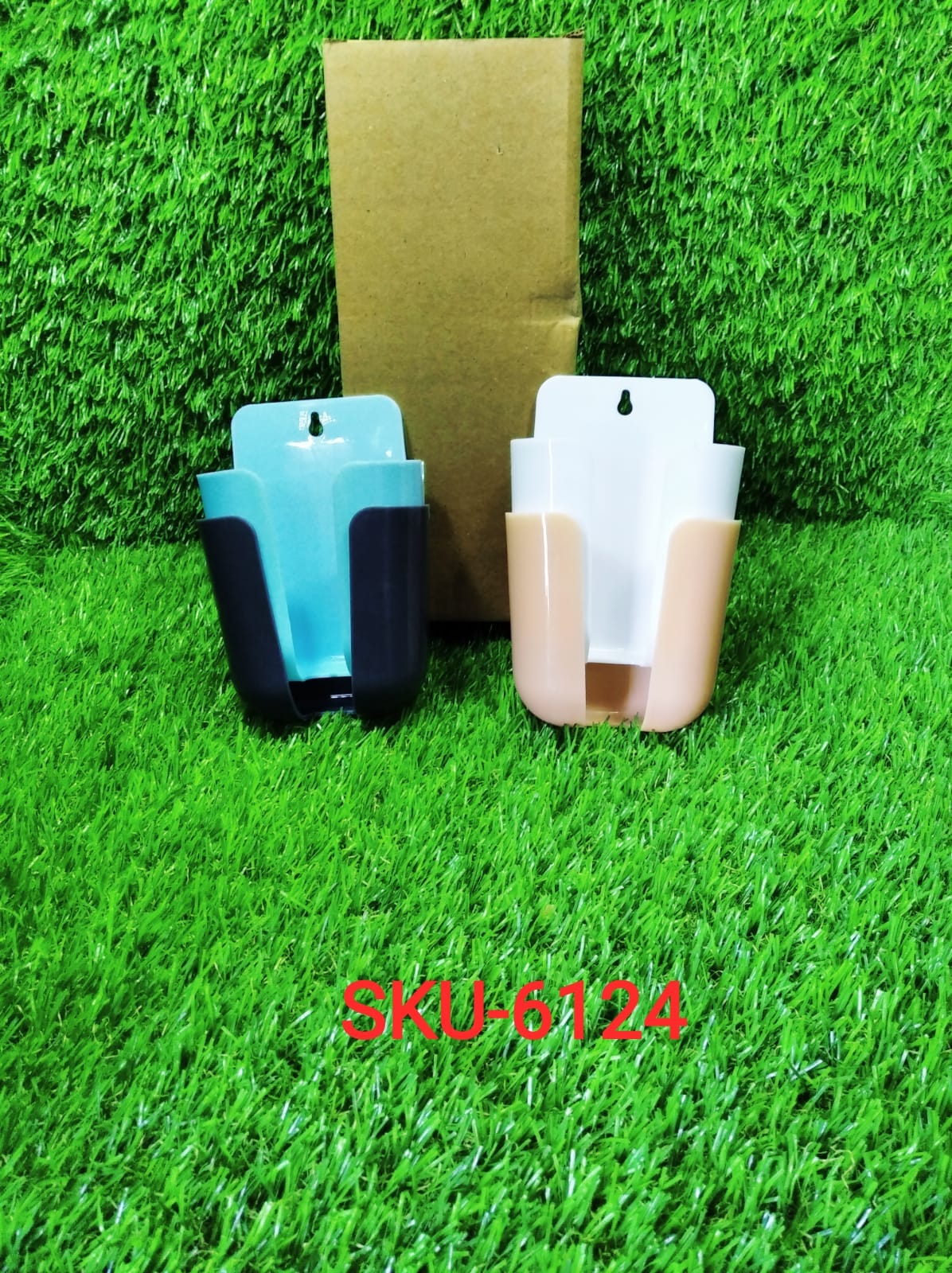 Lifestyle shot of the wall-mounted remote and phone storage in use.