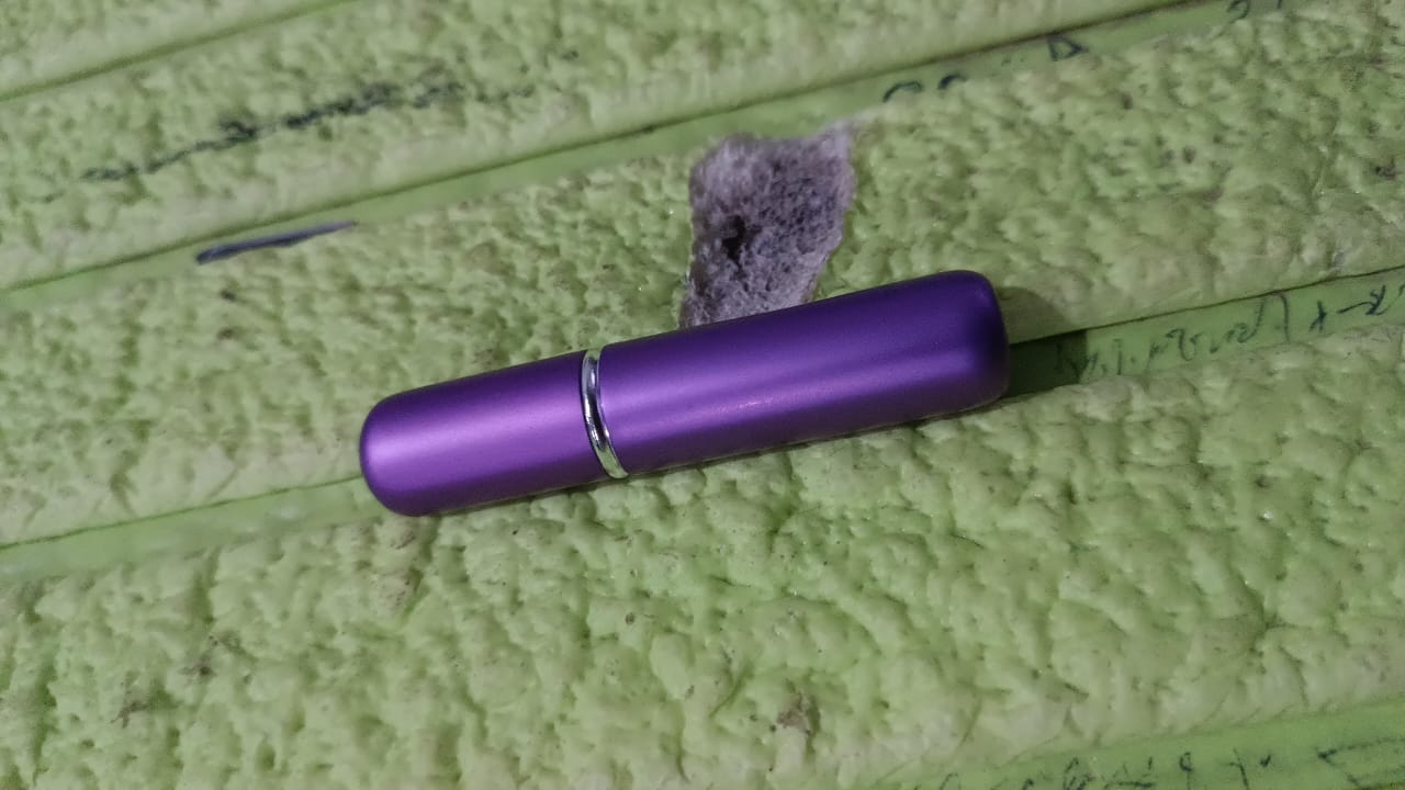 The 5ml portable refillable perfume bottle held comfortably in a hand.