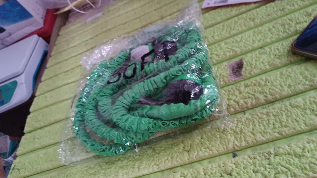 Lifestyle shot of the expandable garden hose being used for car washing.